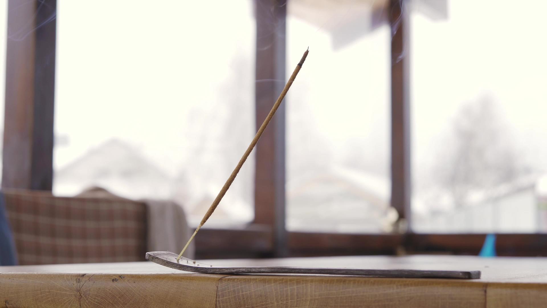 香棒在阳台的木桌上抽烟气味来自昆虫视频的预览图