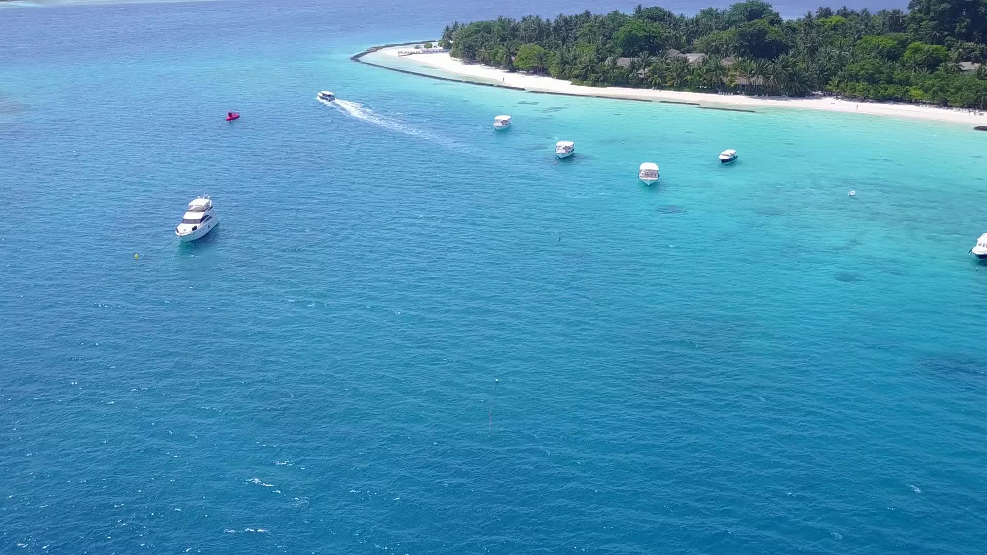 在蓝色的绿色海洋和白色的沙滩背景下打破了岛屿海滩的松散平面全景视频的预览图