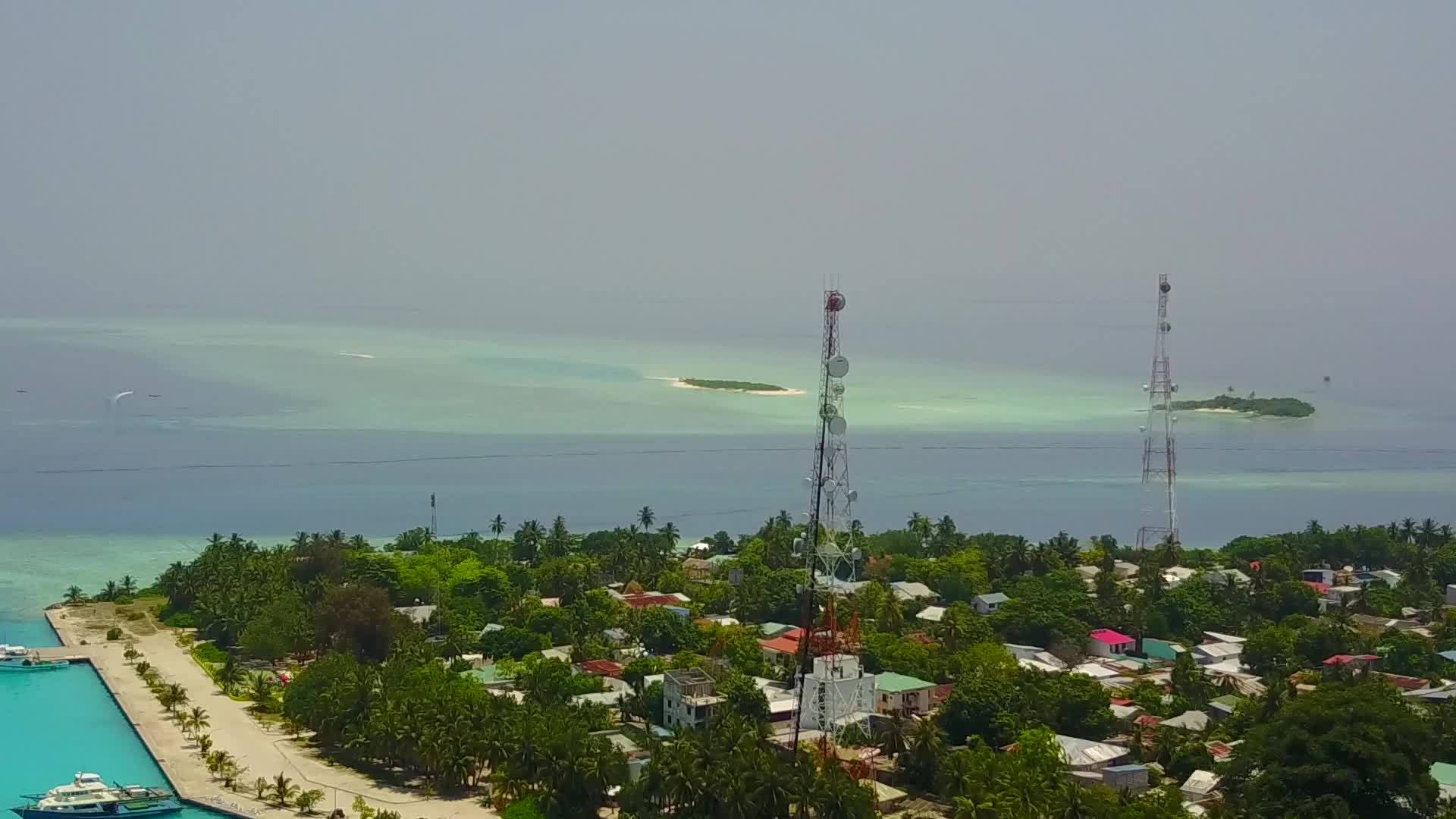 无人驾驶飞机在蓝色水域和白色沙尘的海岸海滩旅行视频的预览图