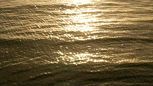 在热带海滩上惊人的日落中海滩上的海浪和阳光反射在海滩上视频的预览图