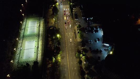 航拍夜晚的城市街道和灯光网球场视频的预览图