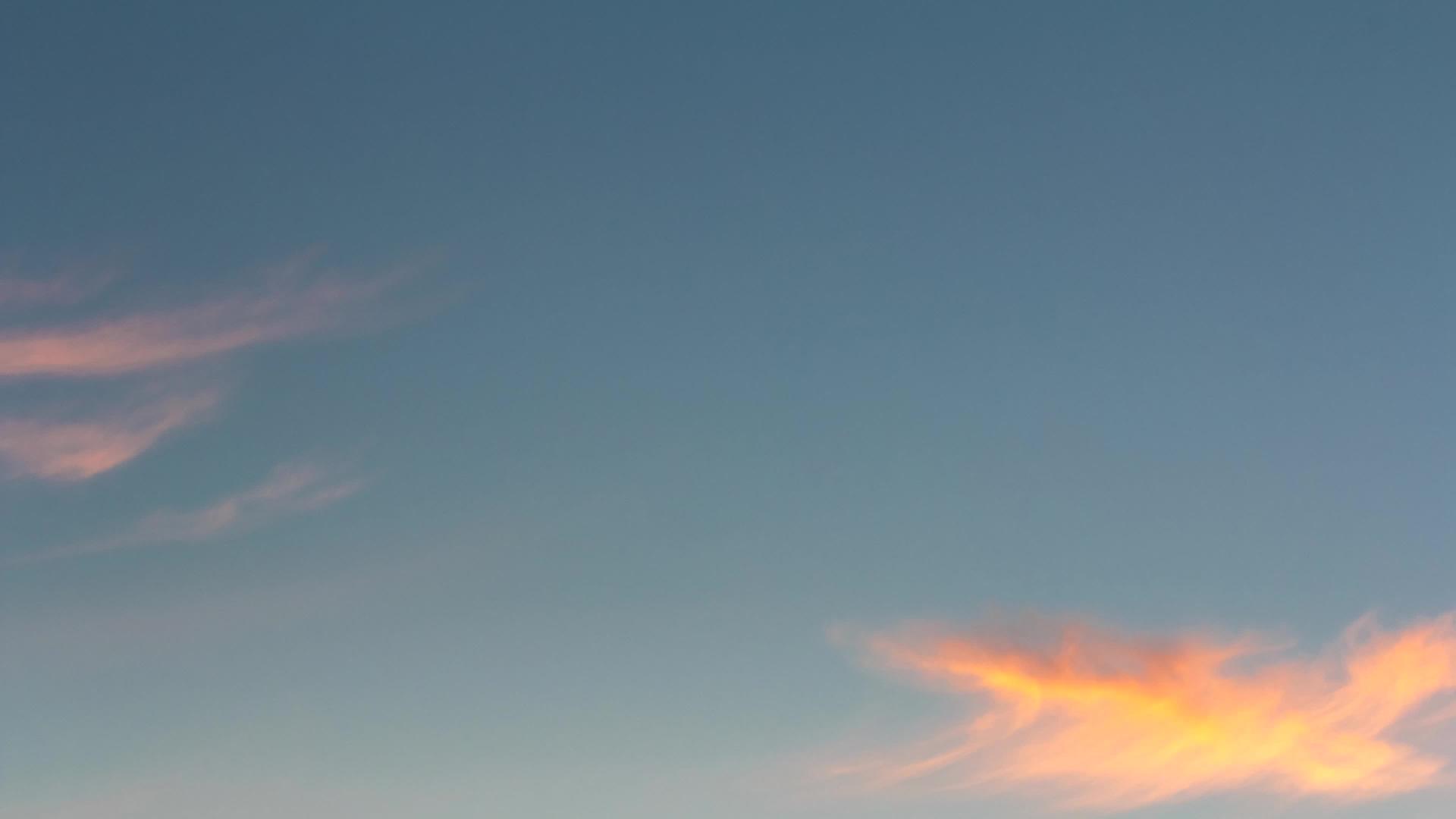 粉色黄云在蓝色天空中的快速移动视频的预览图
