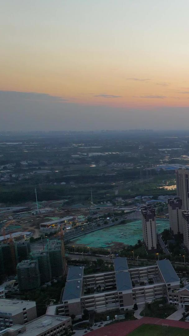 航拍城市傍晚时分夕阳西下房地产行业视频的预览图
