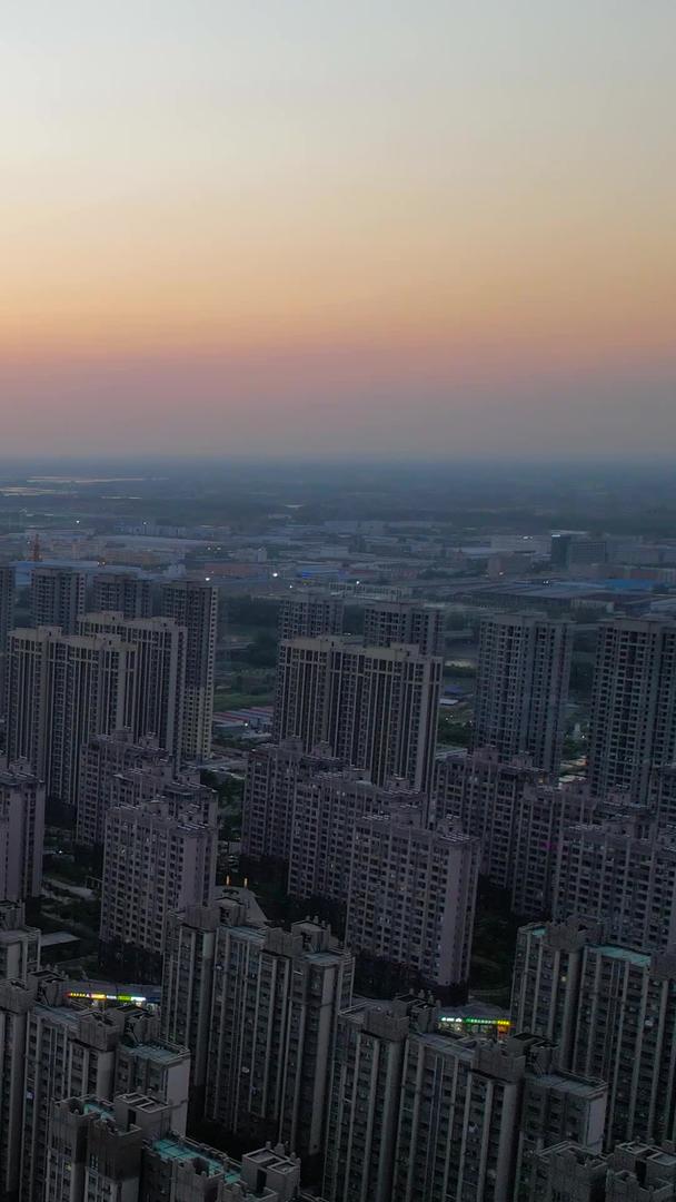 航拍城市傍晚时分夕阳西下房地产行业视频的预览图