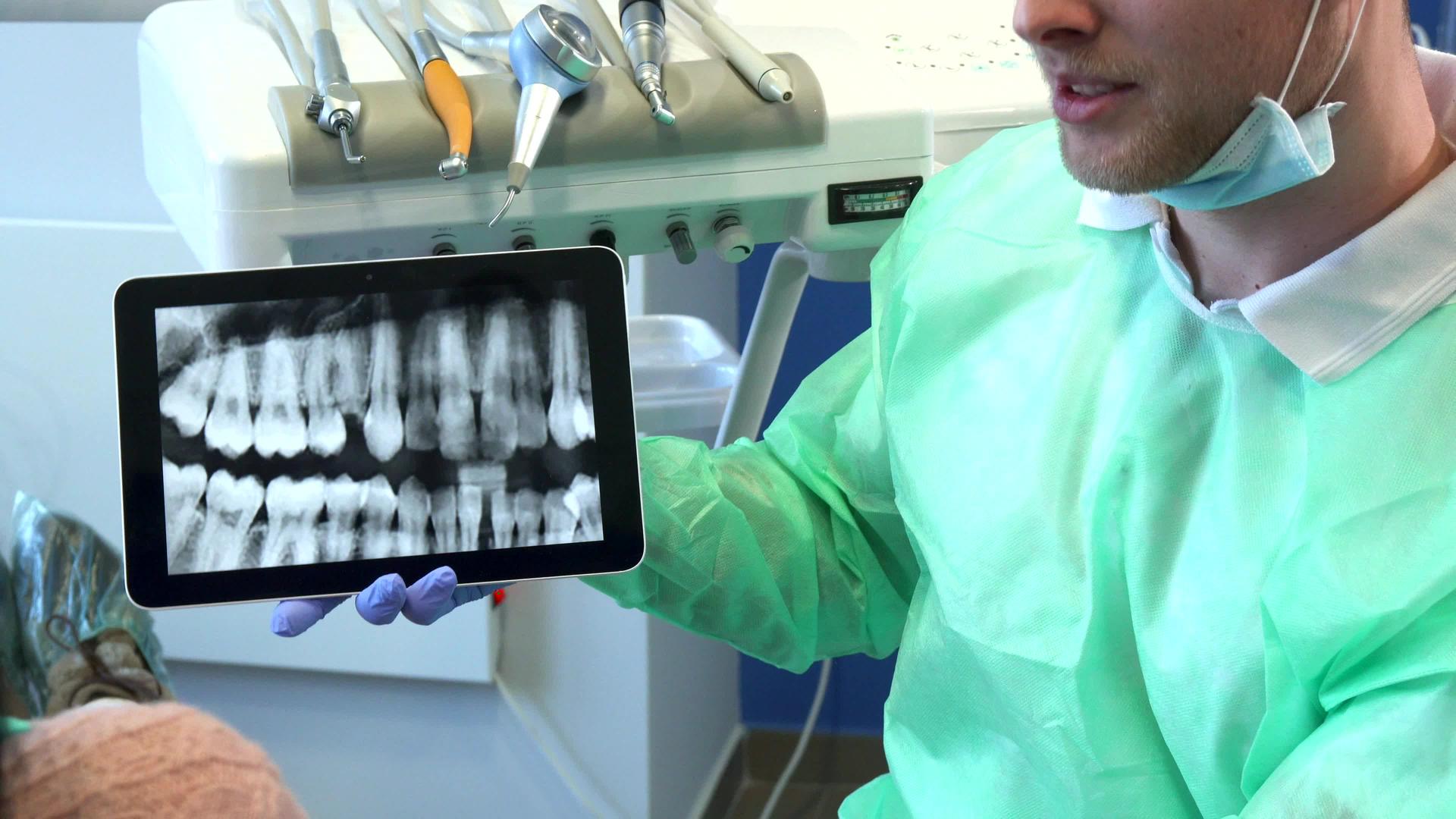 牙医在平板电脑上移动x光图像视频的预览图