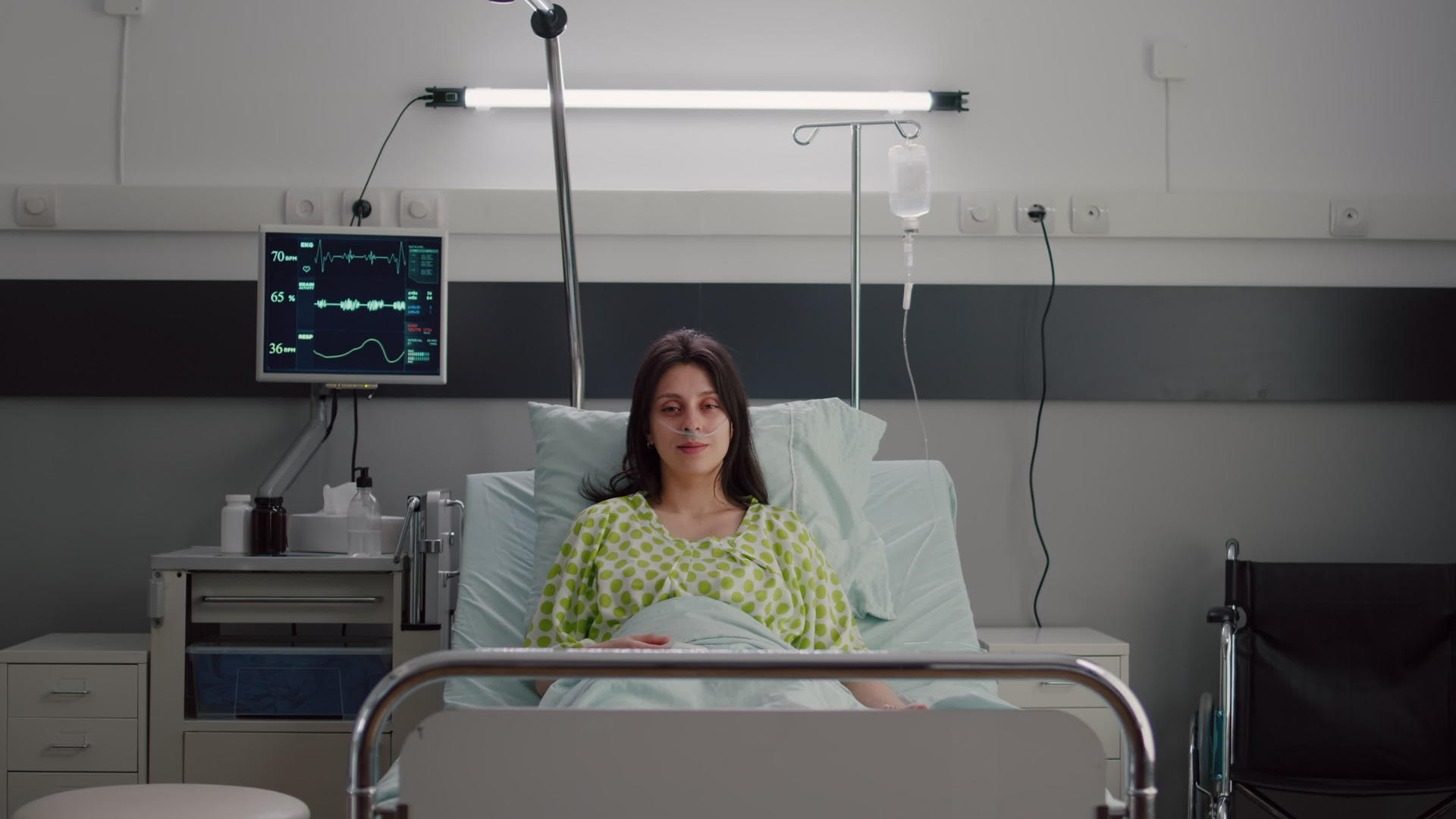 病人躺在床上穿着鼻氧管看着相机头视频的预览图