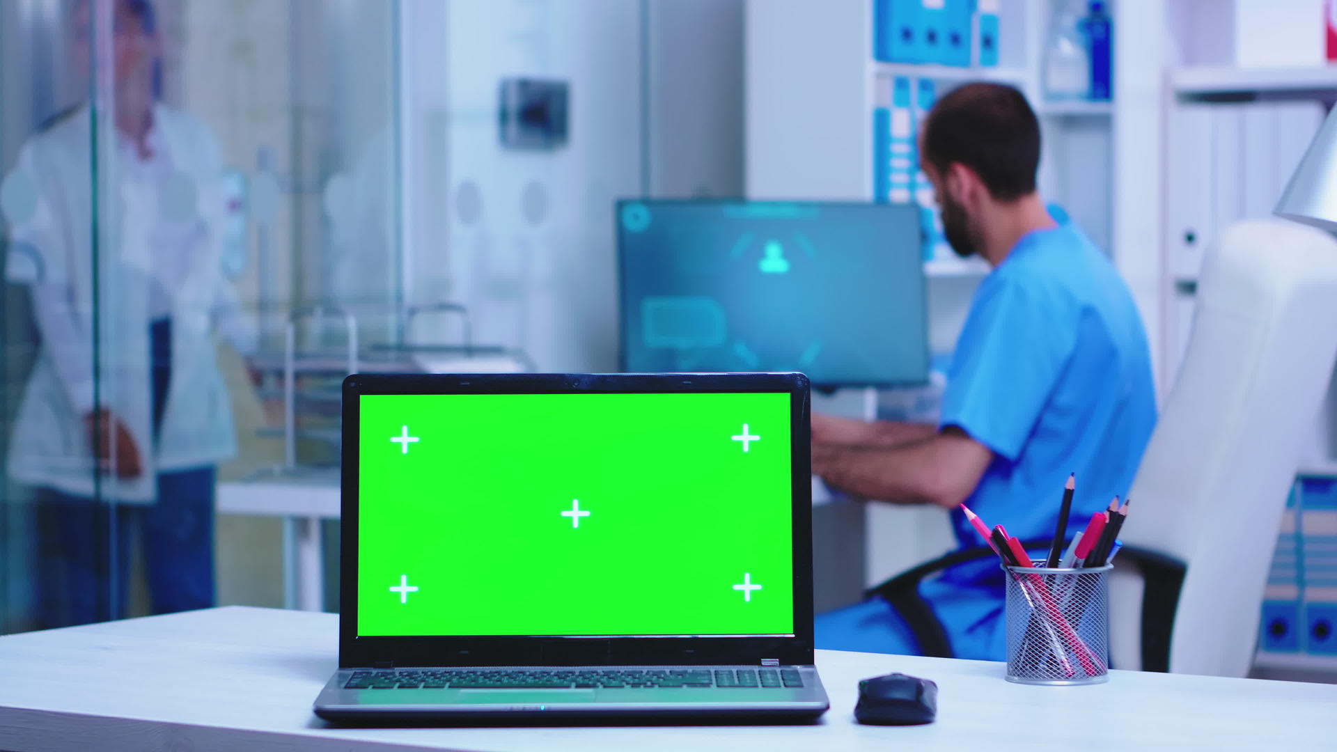 医生坐在绿屏电脑后面视频的预览图