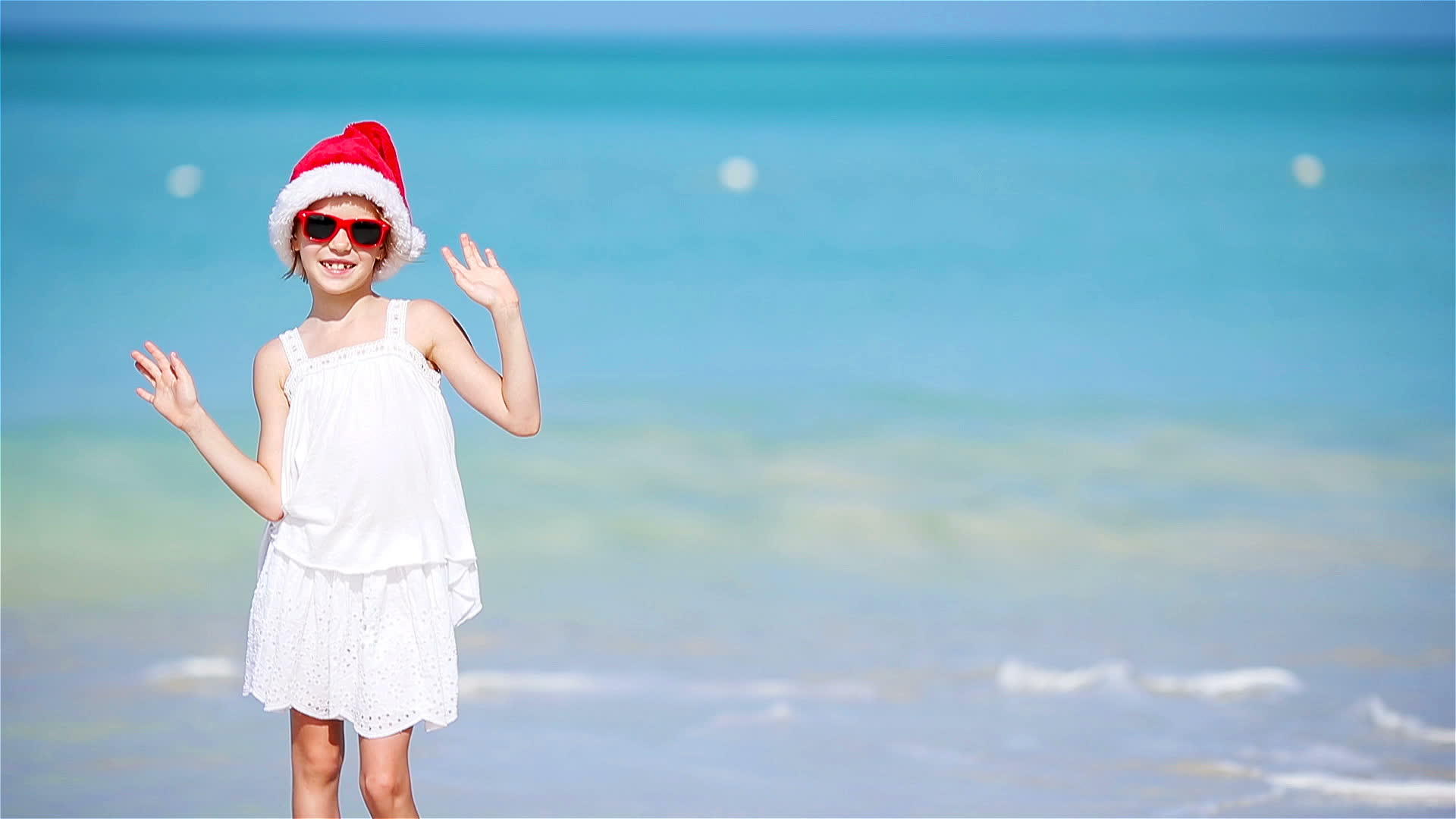 圣诞节期间戴着圣诞帽上戴着圣诞帽的小女孩开心地笑了视频的预览图