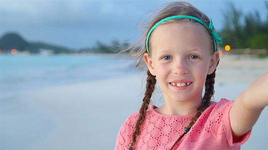 暑假期间快乐的小女孩在奇怪的岛屿热带海滩自拍视频的预览图