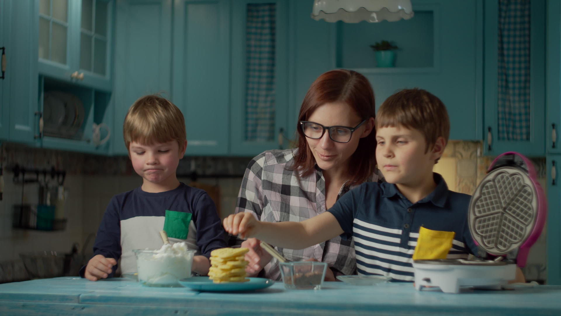 帮助两个孩子在自制的华夫饼上加入奶油和巧克力孩子们喜欢视频的预览图