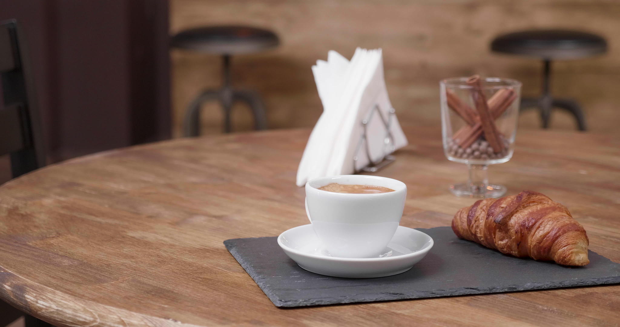 一杯白咖啡加一条羊角面包纸巾和一杯肉桂视频的预览图
