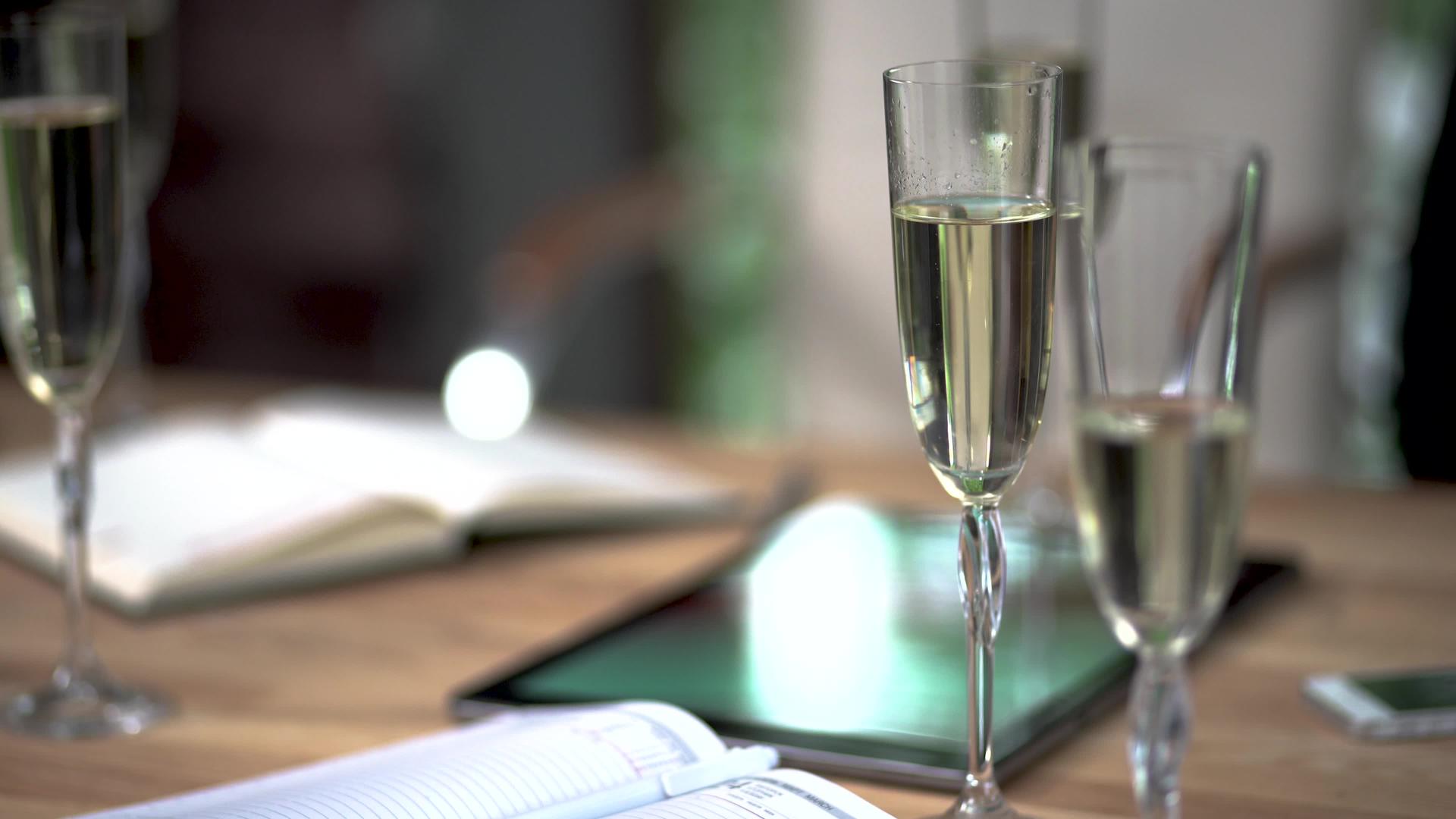 会议室经理桌面上的一杯香槟和一本日记视频的预览图