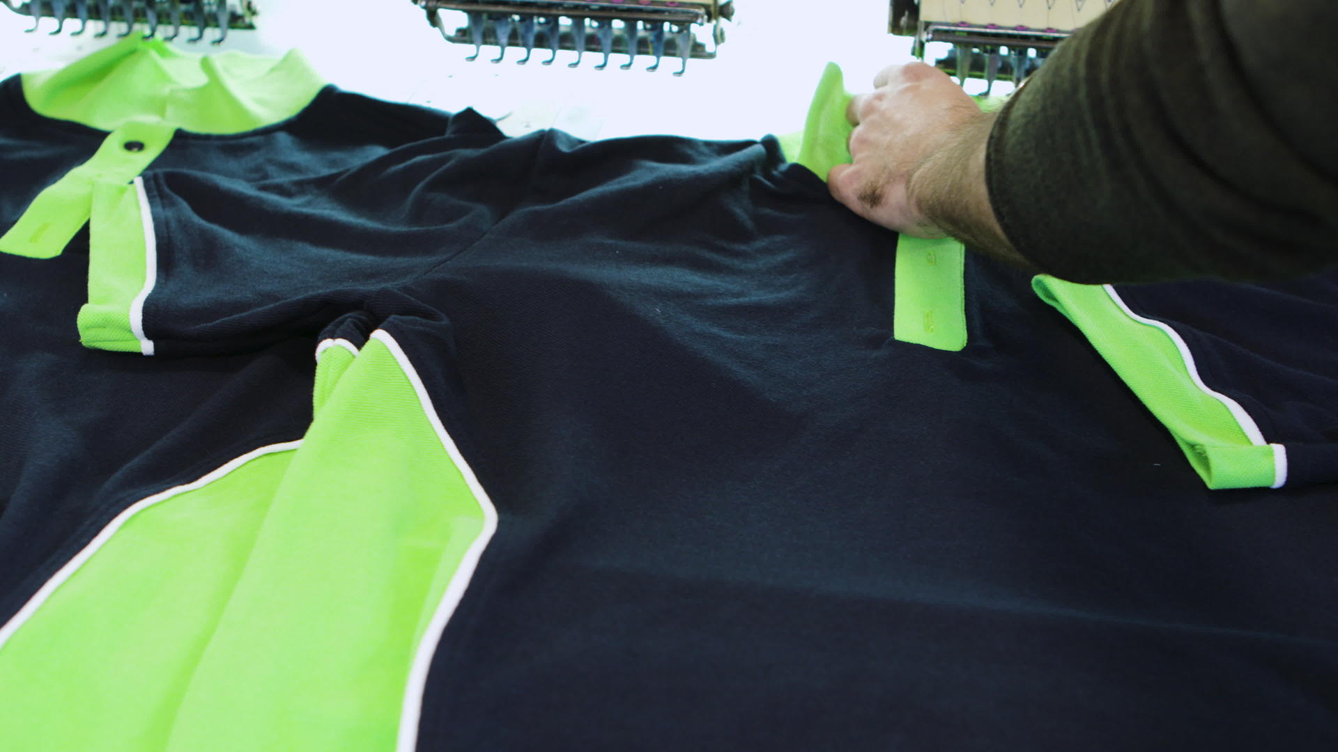 男人在纺织厂检查T恤上的缝纫视频的预览图