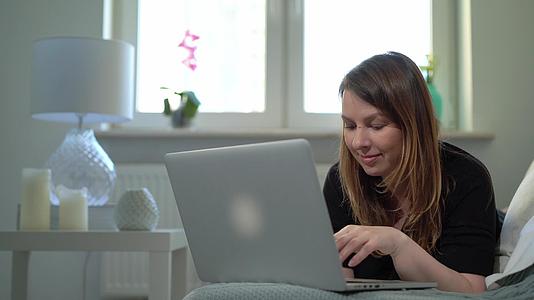 在家远程使用电脑和笔记本电脑的年轻女性a视频的预览图