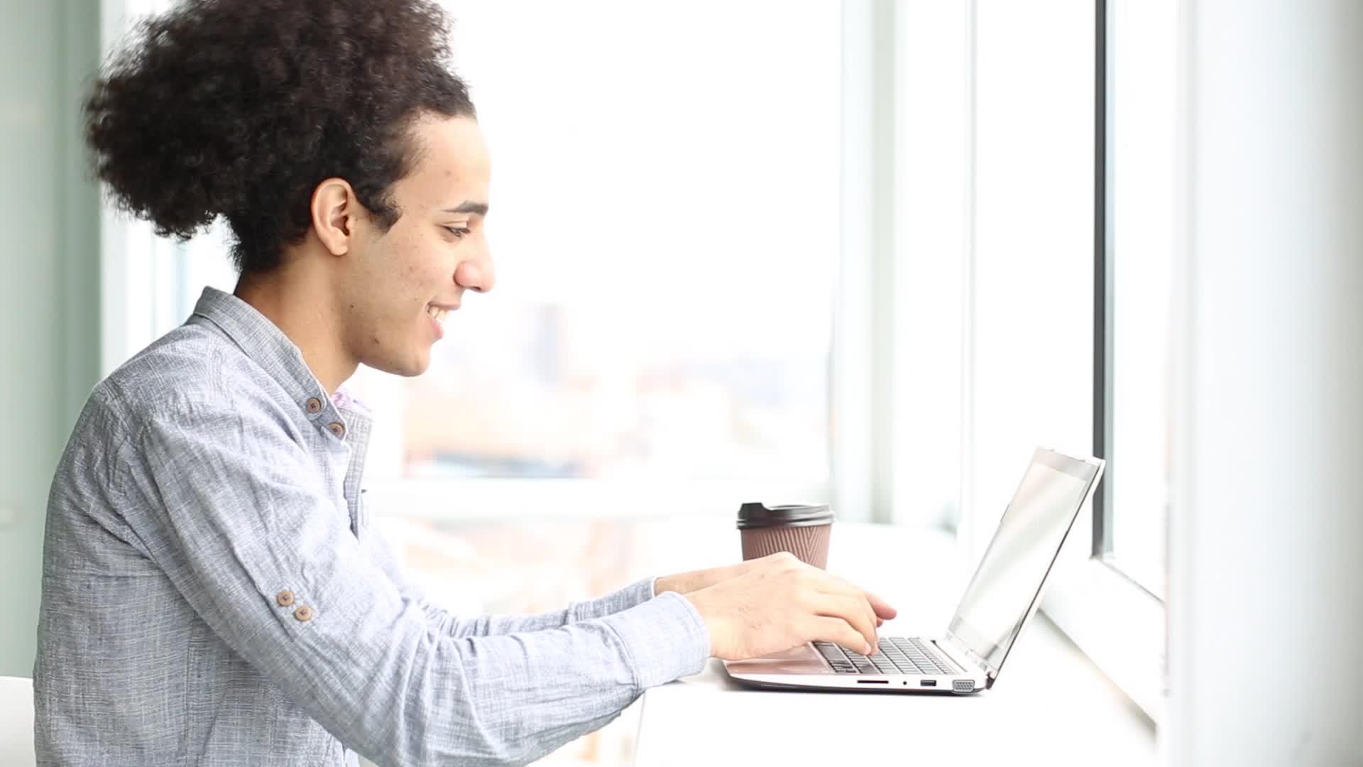 年轻人用笔记本电脑工作喝咖啡视频的预览图