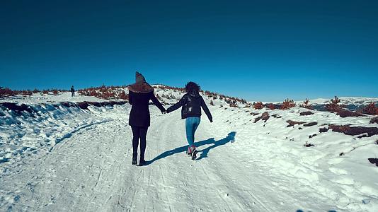 两个快乐的青少年在雪地上微笑视频的预览图