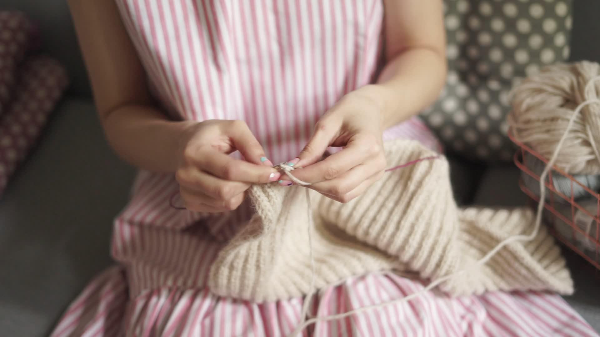 坐在沙发上编织羊毛的女人靠近女性编织手视频的预览图