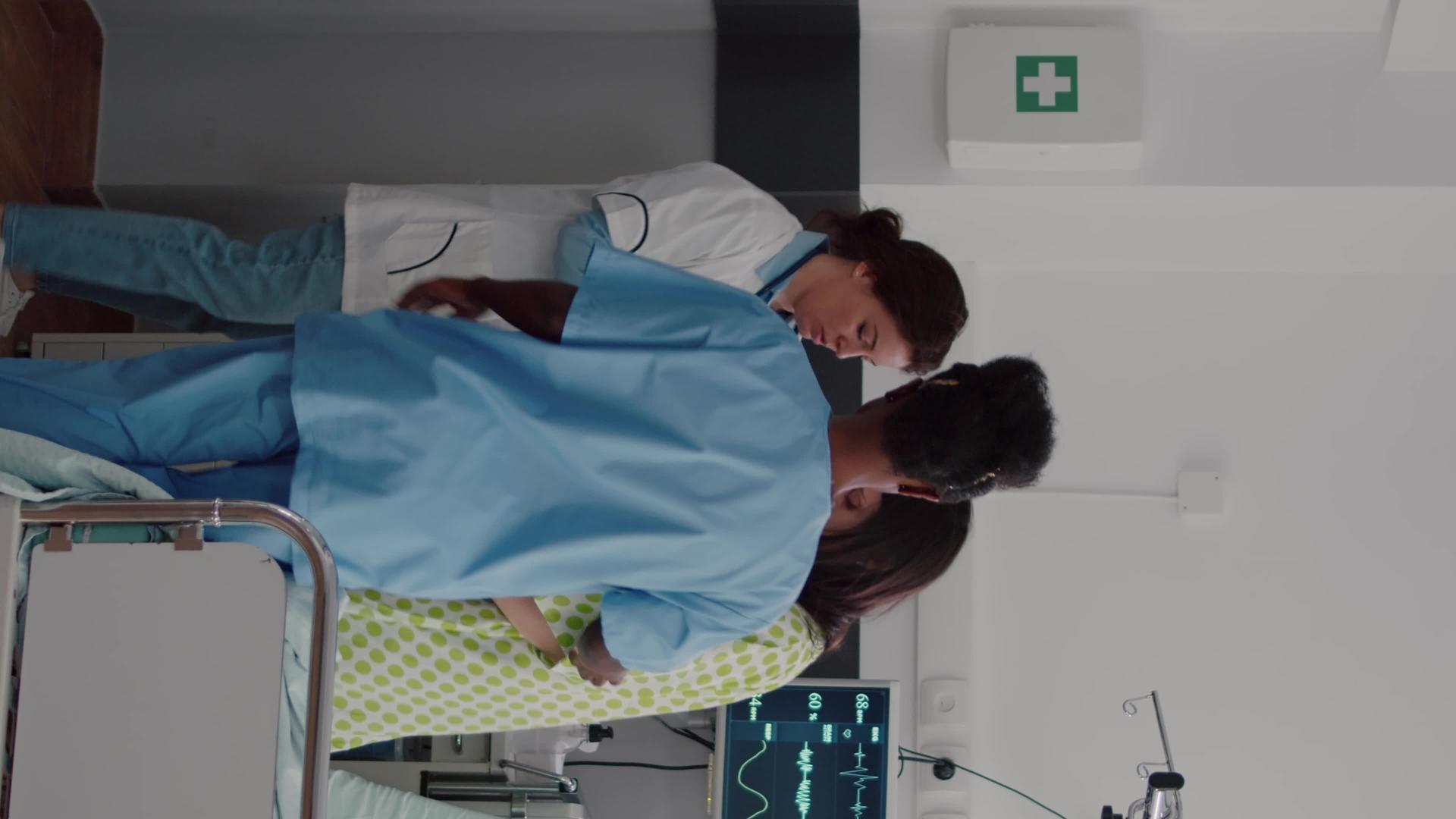 美国护士和医生帮助病人从床上站起来他带来了医生垂直版视频的预览图