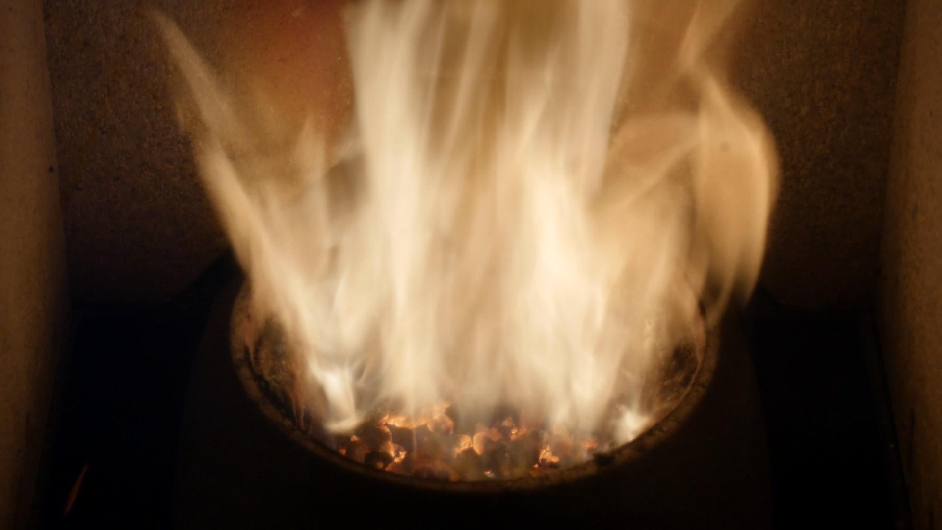 火焰中的颗粒-橡木生物质特写加热-可再生能源的木材颗粒视频的预览图