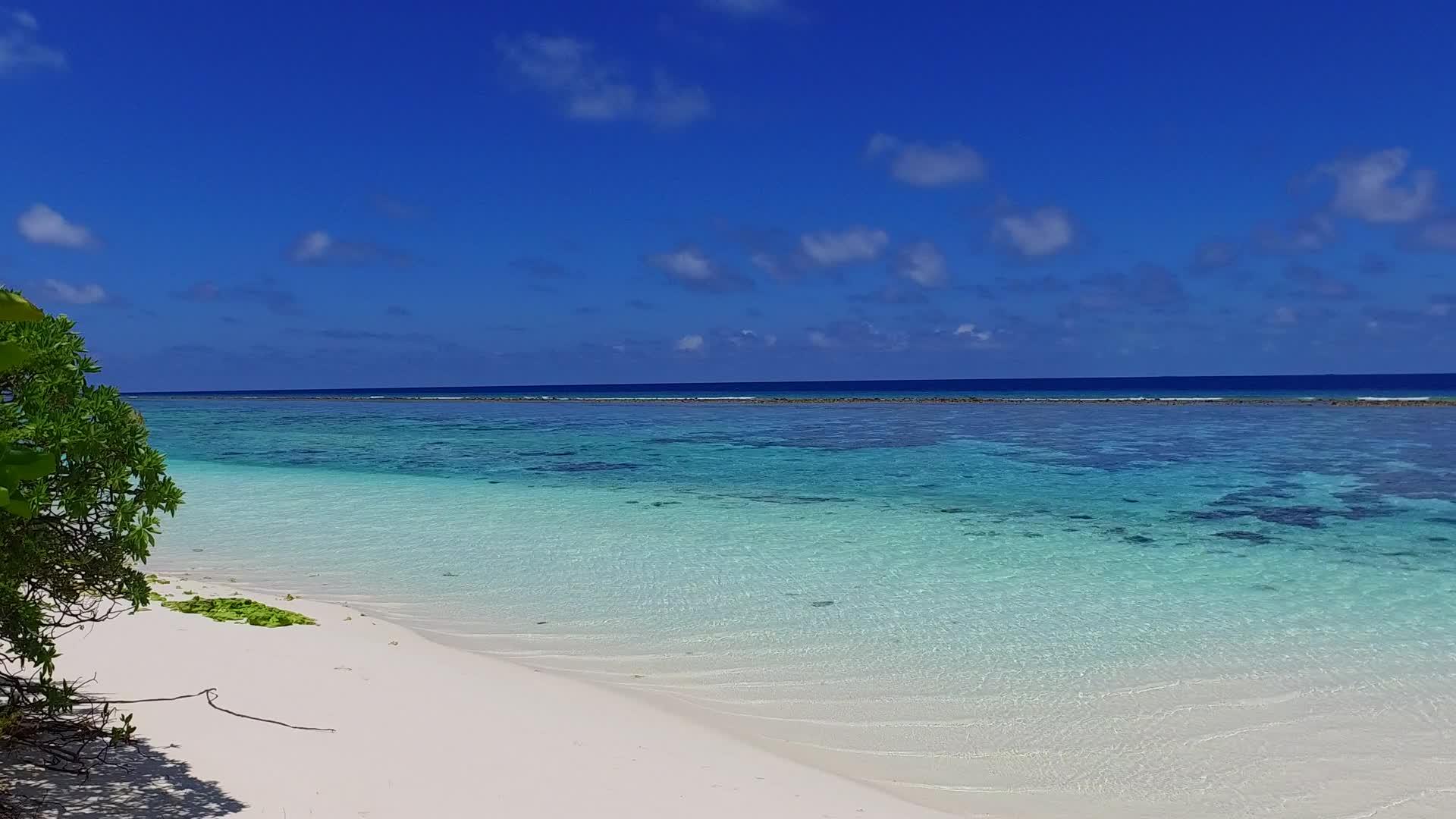 绿松石环礁湖度假旅游海滩海浪附近有白色沙滩背景视频的预览图