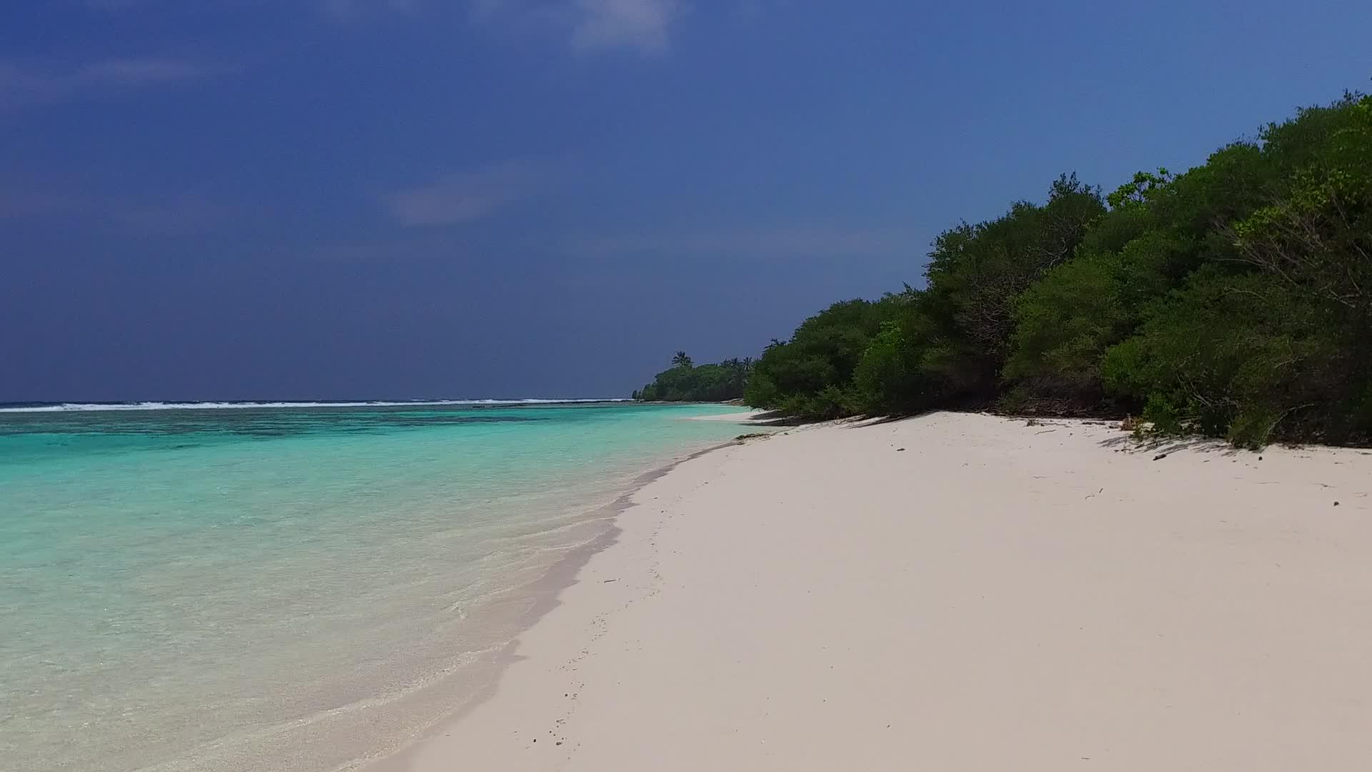 海滩以阳光下白沙背景的清水为航程平静而寒冷视频的预览图