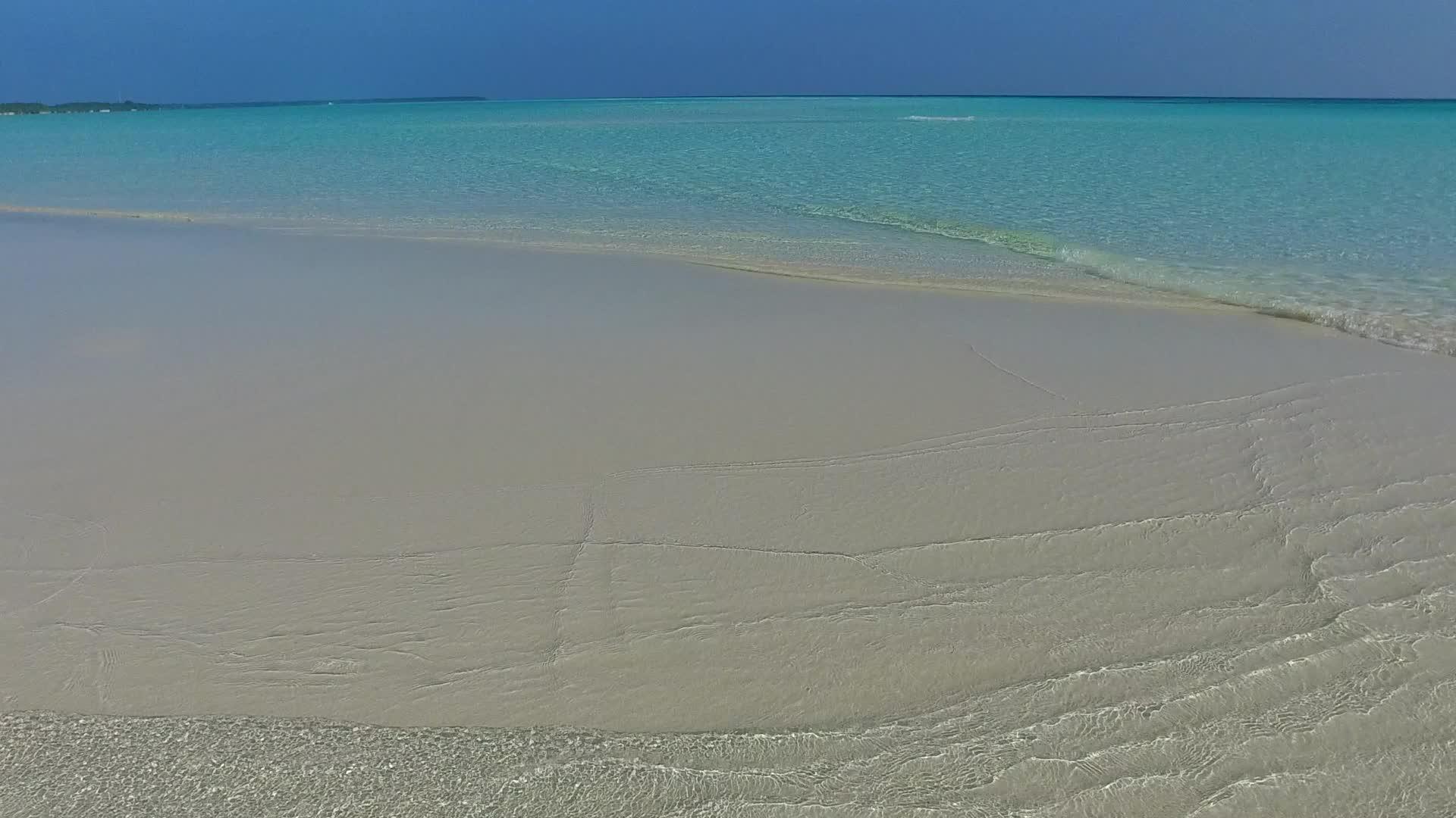 日落前清晰的环礁湖以白色沙子为背景关闭了海面视频的预览图