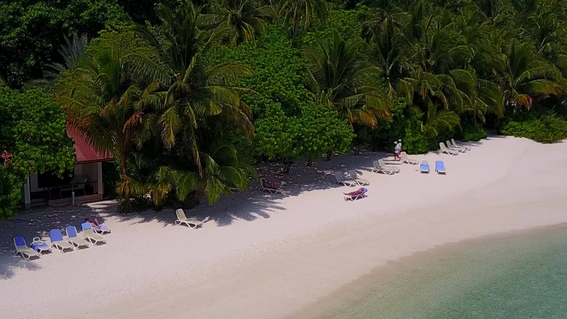 在海滩附近的蓝色水域和白色沙滩上在白色沙滩上浪漫地旅行视频的预览图