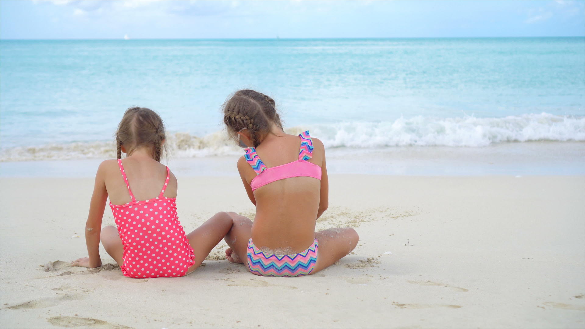 暑假期间可爱的小姐妹们在海滩上度假视频的预览图