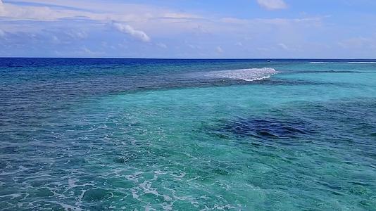 海滩附近的蓝环礁和白色沙底背景的阳光明媚的风景视频的预览图