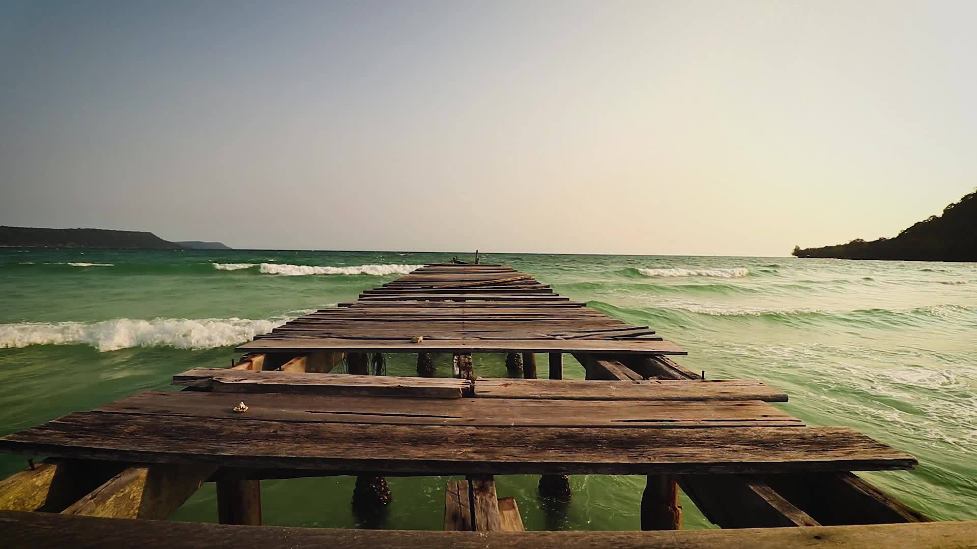 一个破碎的木制码头在开阔的海面上视频的预览图