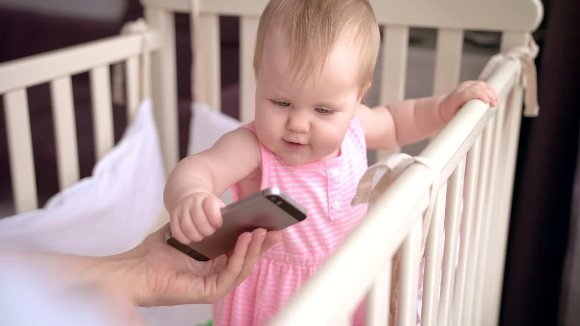 婴儿床小可爱触摸智能手机婴儿技术概念视频的预览图