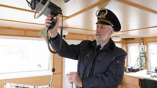 胡须船长导航员在船长桥上设置收音机管理现代船舶视频的预览图