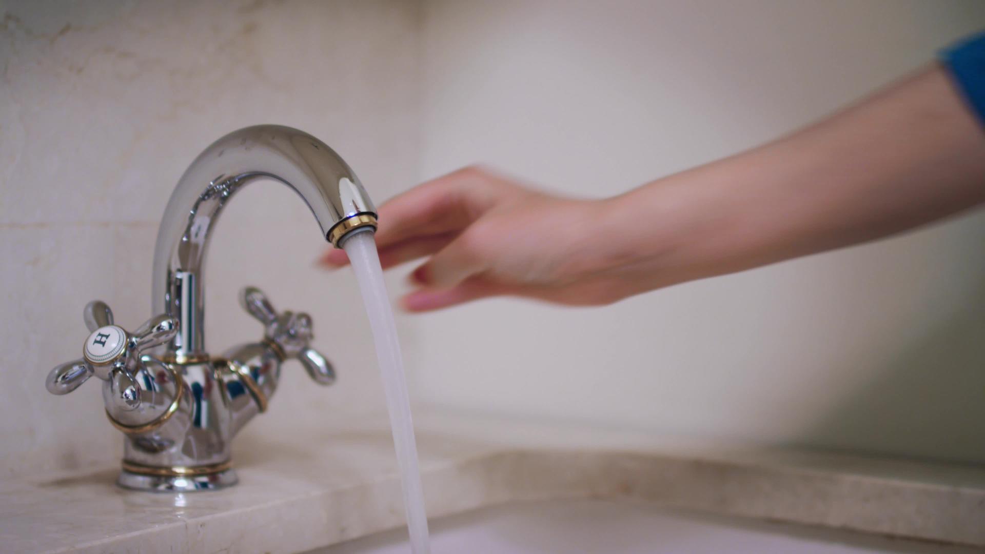 女人用手把水龙头倒进浴室缸里视频的预览图