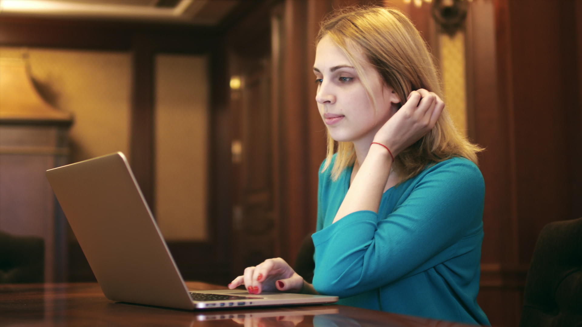 年轻女性在屏幕上看笔记本电脑和键盘打字视频的预览图