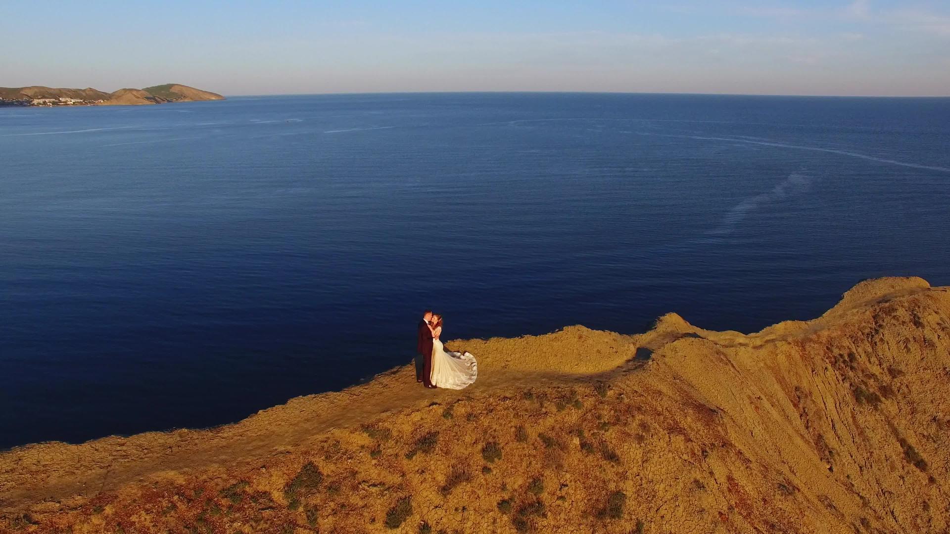 日落时新娘和新郎在空山上行走视频的预览图