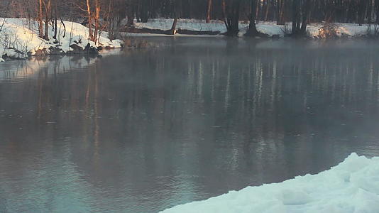 在河岸寒冷的天气里冬天雪漂流视频的预览图