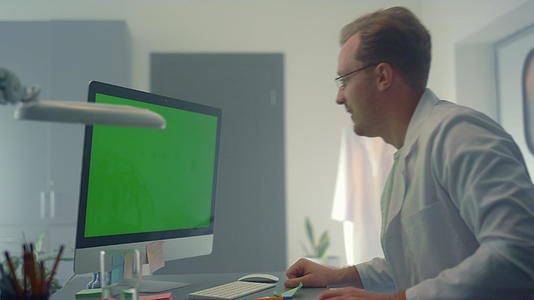 在医院工作的医生使用计算机进行远程咨询视频的预览图
