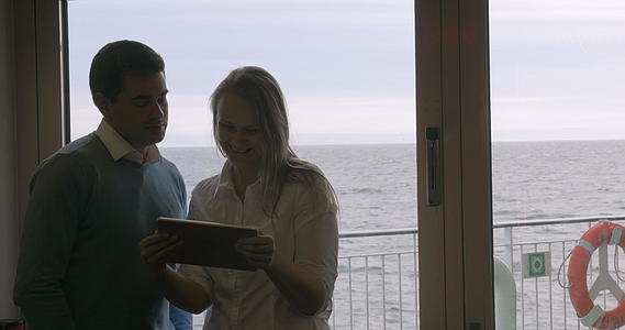 年轻夫妇在船上使用平板电脑视频的预览图