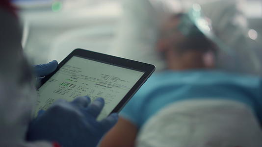 医生在病房里用平板电脑屏幕检查病人的病史视频的预览图