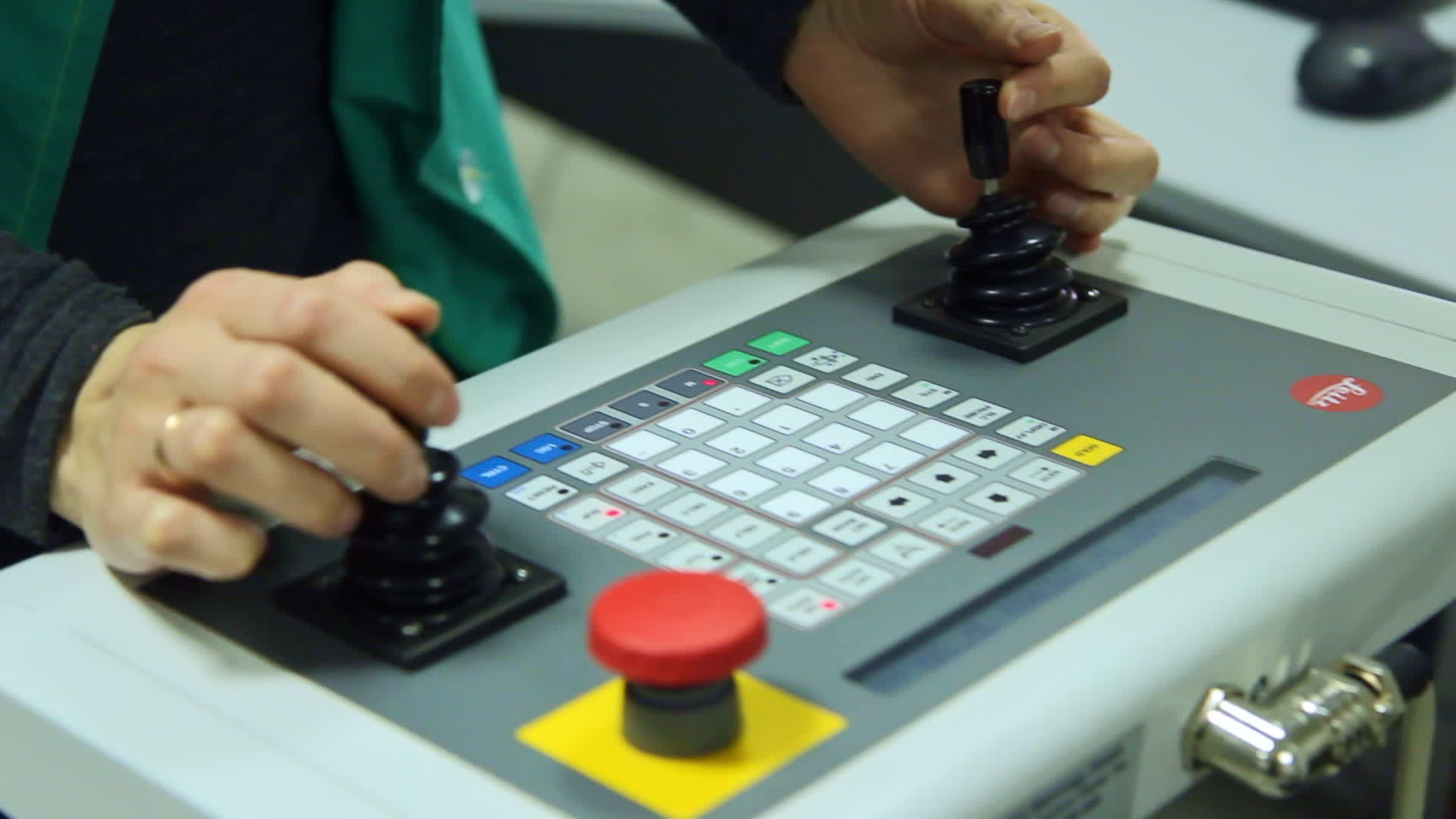 工人在控制面板上使用两个操纵杆来管理生产过程视频的预览图