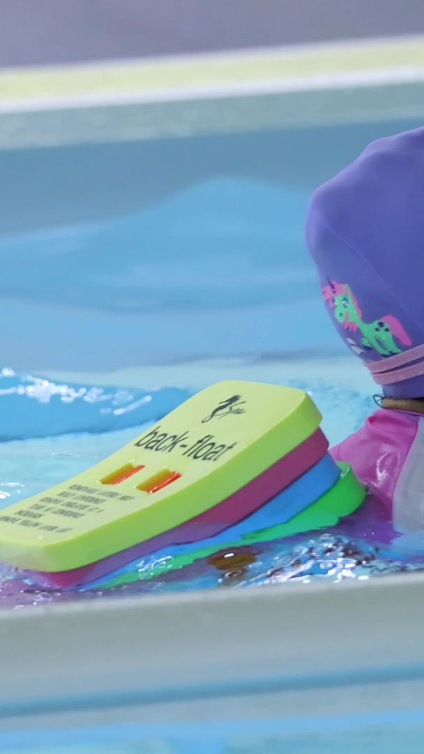 在游泳池里练习游泳的小女孩视频的预览图