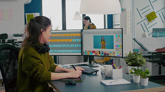 使用两个显示器和钢笔在计算机上工作的妇女改革者视频的预览图