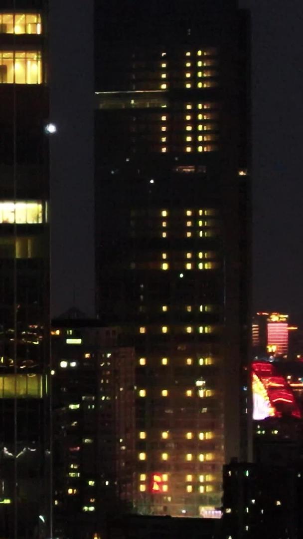 航拍城市夜景写字楼互联网公司灯火通明办公楼加班材料视频的预览图