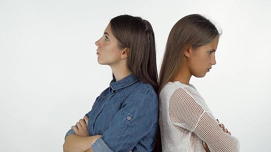 两个女朋友背靠背站着愤怒地看着自己视频的预览图