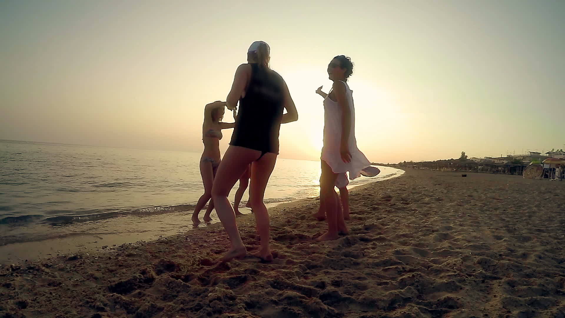 女孩们在阳光明媚的白天在海滩上慢慢地跳舞视频的预览图