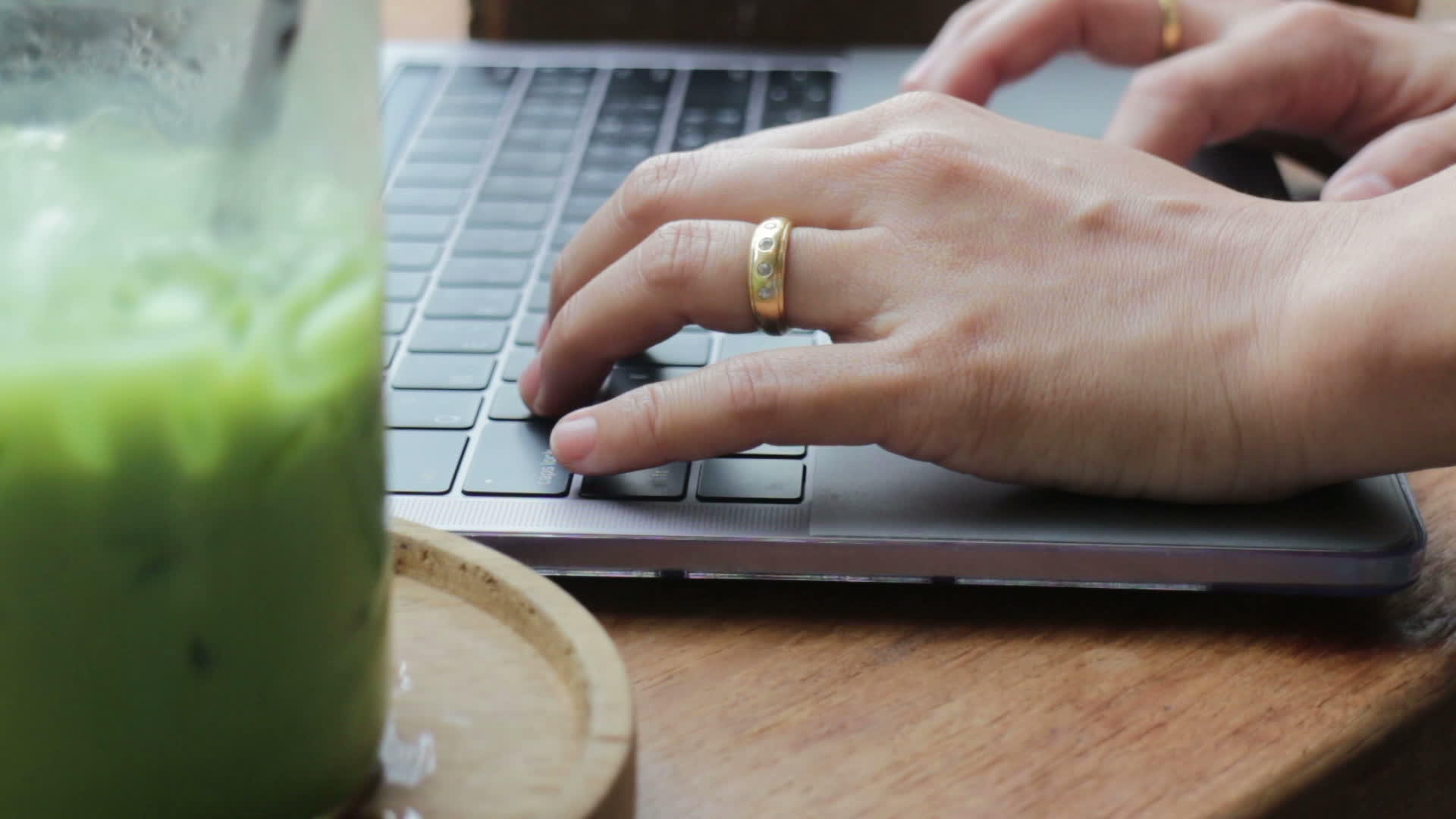 女性用笔记本电脑打字喝冰红茶视频的预览图