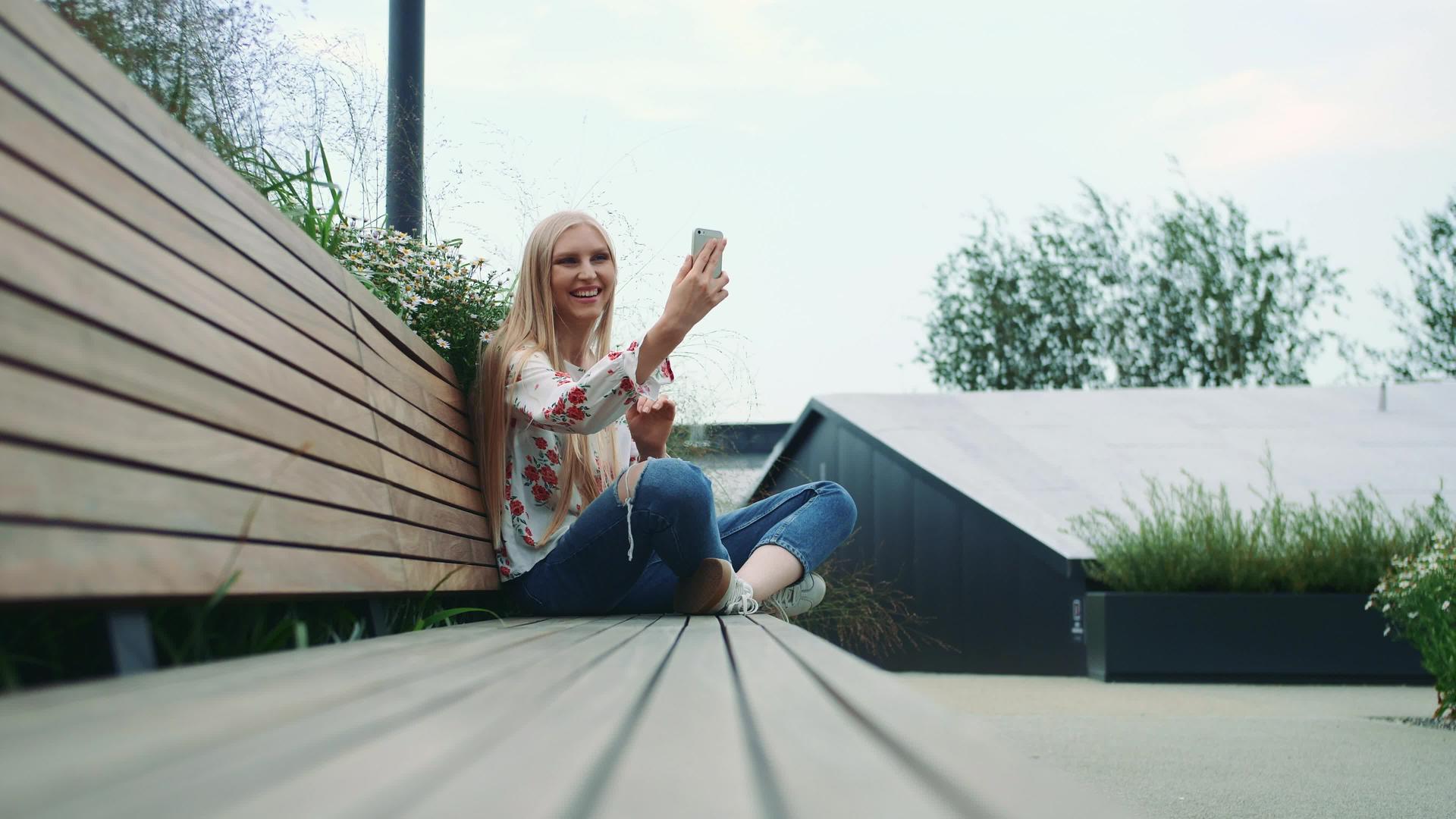 这位年轻女士在绿色屋顶上做了一个视频呼叫视频的预览图