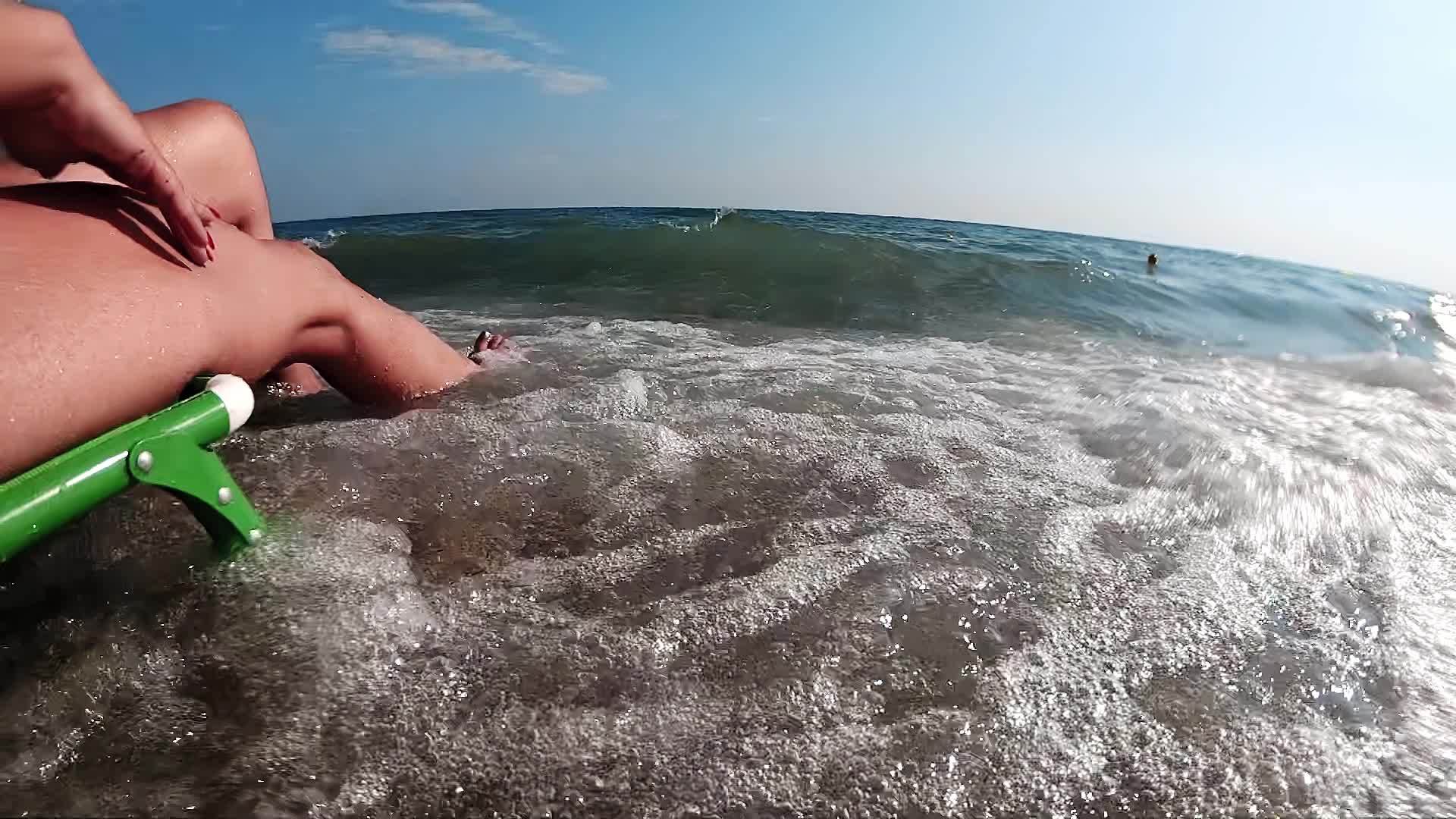 在浅海和海浪中女性的双腿在岸边放松和清新地慢慢移动视频的预览图