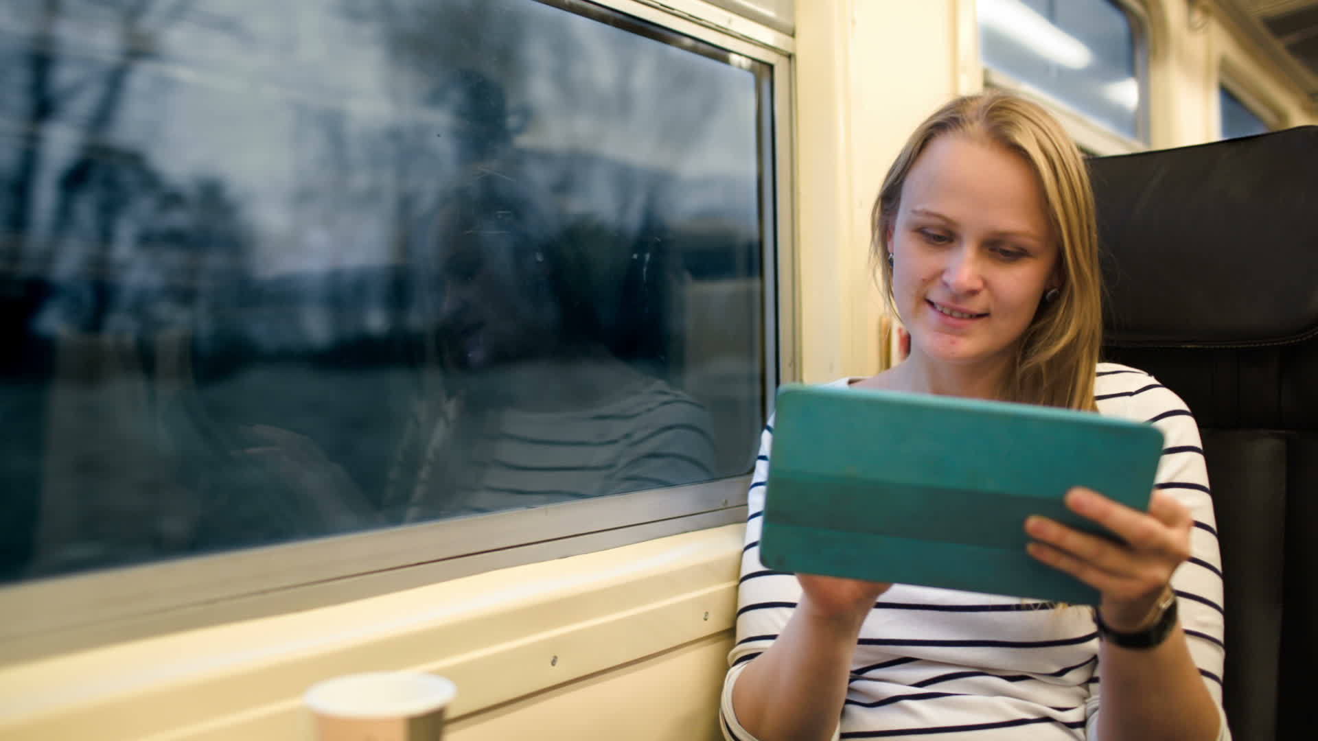女人用触摸板和女人在火车上喝茶视频的预览图