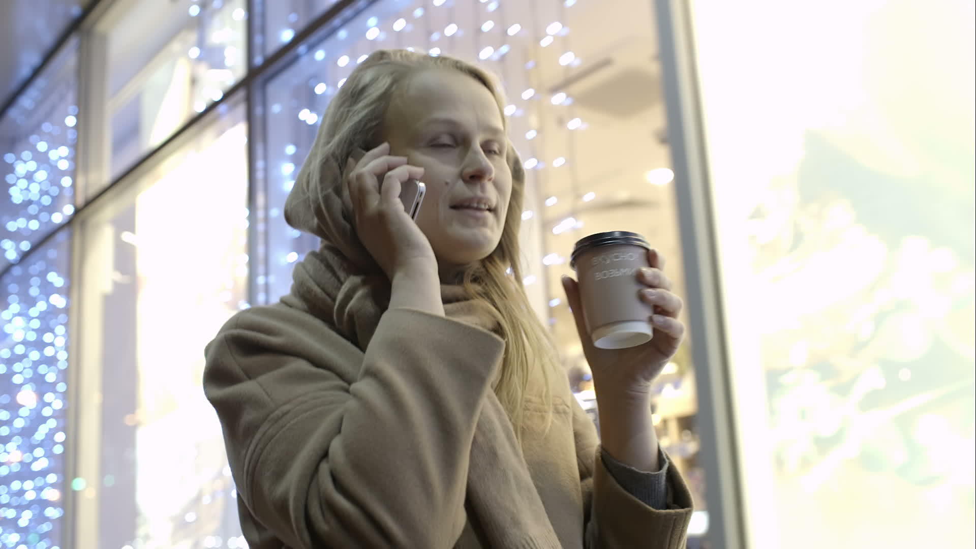 当女人走在街上时她们通过电话喝咖啡视频的预览图